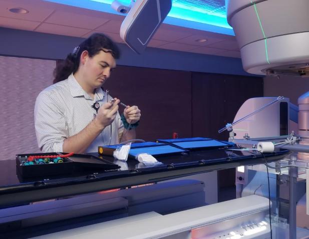 Medical physicist calibrating equipment