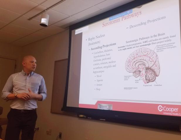 Faculty member facing instructional slides.