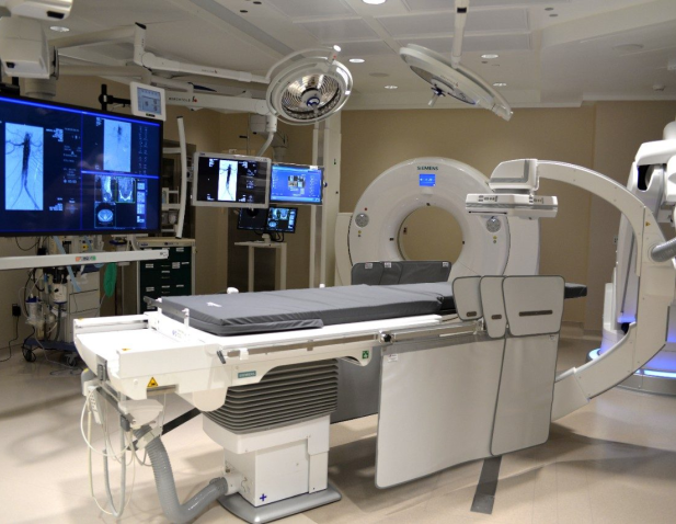 Interventional radiology lab, no people, includes C-Arm.