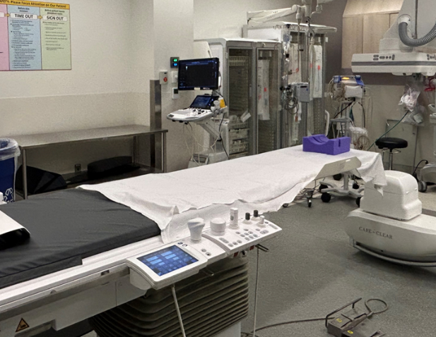 Interventional radiology lab, no people, includes C-Arm.
